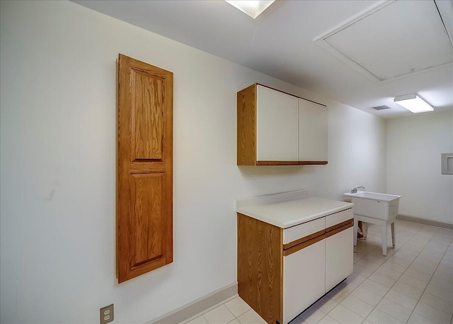 523 Leawood Dr, Frankfort, KY 40601 - kitchen with light countertops, light tile patterned floors, baseboards, and white cabinetry