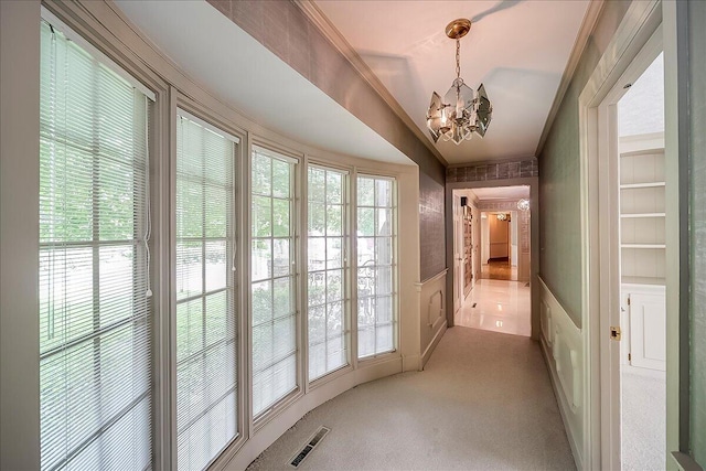523 Leawood Dr, Frankfort, KY 40601 - hall featuring a chandelier, wainscoting, ornamental molding, and light carpet
