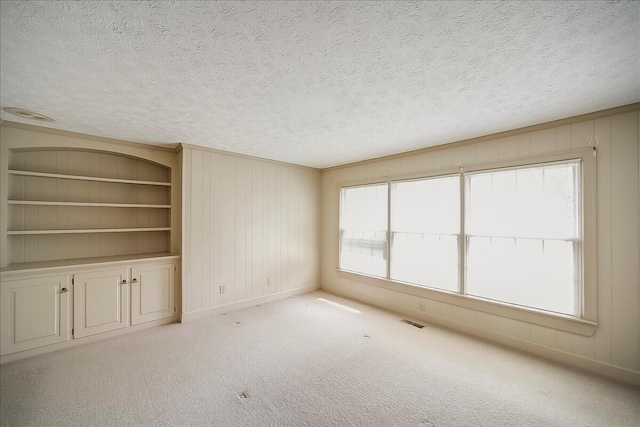 523 Leawood Dr, Frankfort, KY 40601 - carpeted empty room with a textured ceiling, built in features, and baseboards