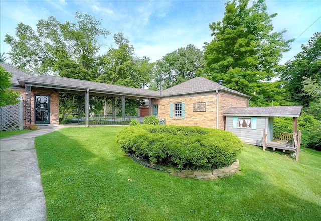 523 Leawood Dr, Frankfort, KY 40601 - view of front of house with brick siding, a front yard, an outdoor structure, and roof with shingles