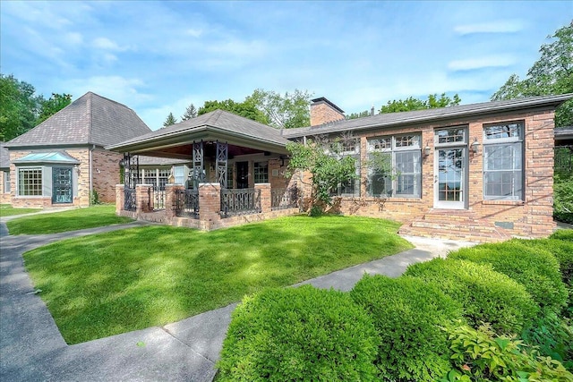 523 Leawood Dr, Frankfort, KY 40601 - view of front facade with a chimney, a front lawn, brick siding, and entry steps
