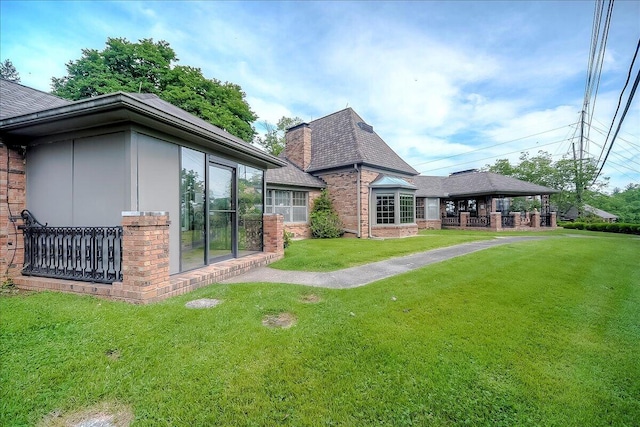 523 Leawood Dr, Frankfort, KY 40601 - rear view of house with brick siding, a yard, and roof with shingles