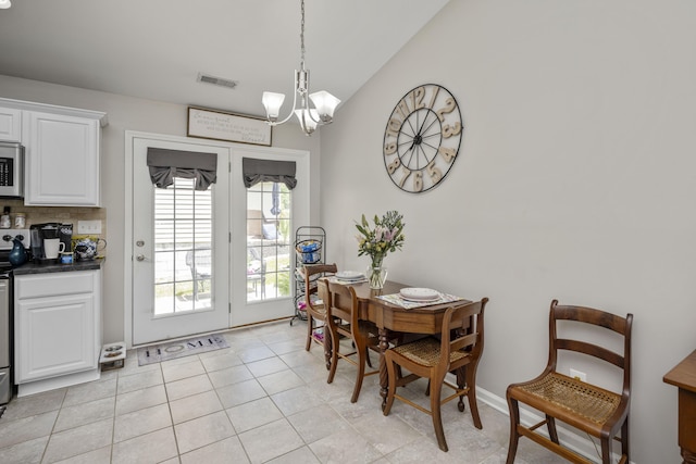 1017 Sugarbush Trl, Lexington, KY 40509 - dining area with a chandelier, vaulted ceiling, and light tile patterned flooring
