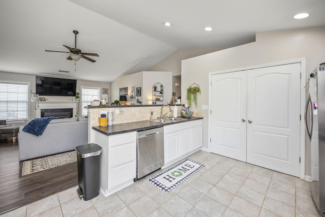 1017 Sugarbush Trl, Lexington, KY 40509 - kitchen with appliances with stainless steel finishes, a sink, ceiling fan, a peninsula, and dark countertops