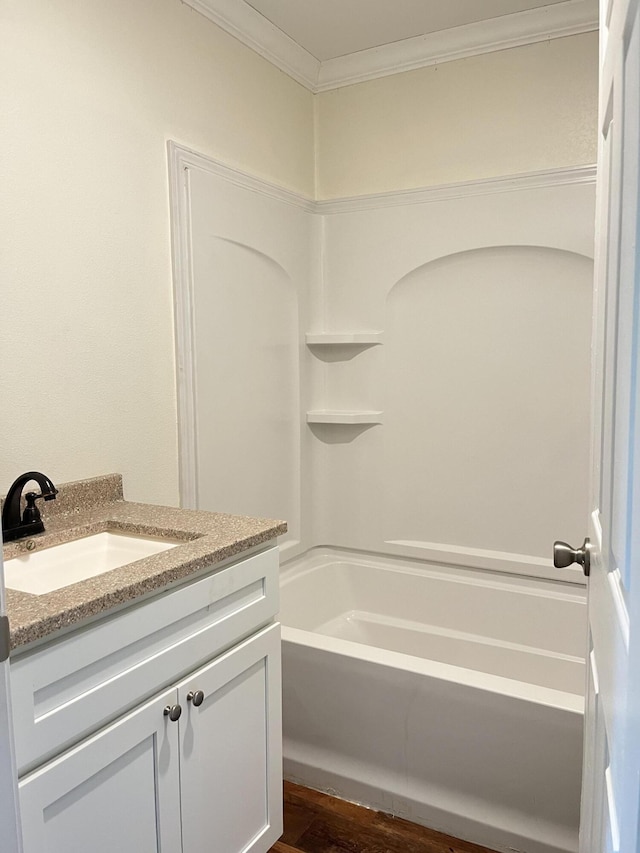 77 Travis Burchfield Rd, Strunk, KY 42649 - bathroom with vanity, washtub / shower combination, ornamental molding, and wood finished floors