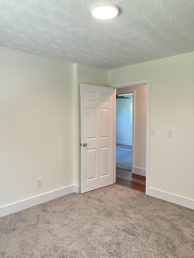 77 Travis Burchfield Rd, Strunk, KY 42649 - carpeted empty room featuring baseboards and a textured ceiling