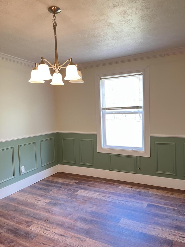 77 Travis Burchfield Rd, Strunk, KY 42649 - empty room with a chandelier, a wainscoted wall, crown molding, a textured ceiling, and dark wood finished floors