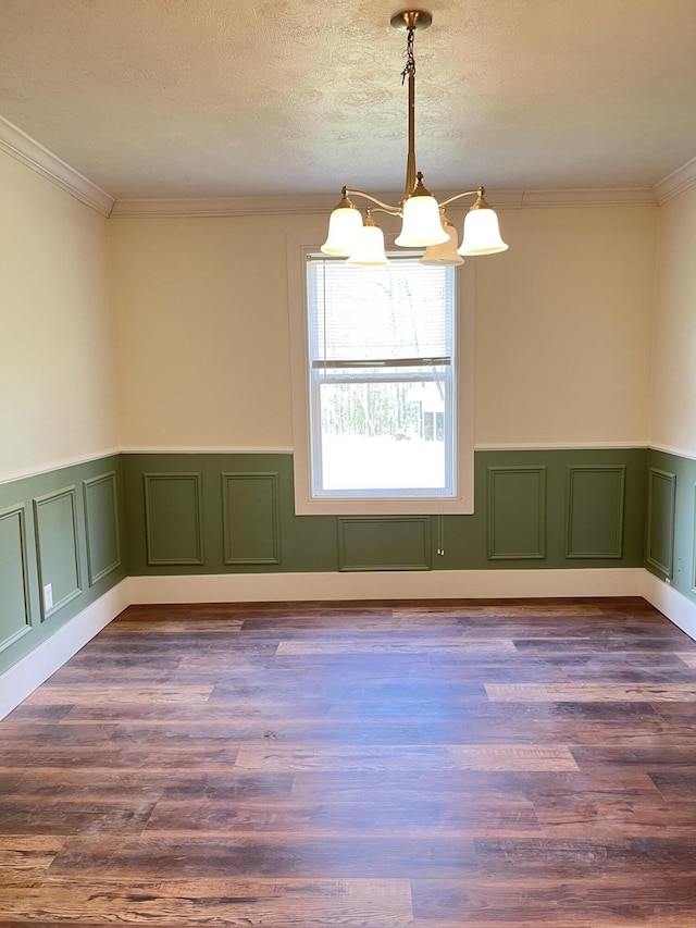 77 Travis Burchfield Rd, Strunk, KY 42649 - unfurnished room with a chandelier, a wainscoted wall, crown molding, dark wood-style flooring, and a textured ceiling