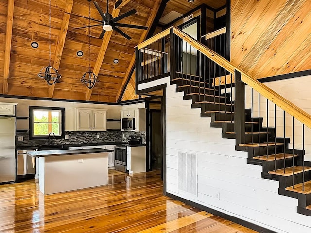 495 Pumpkin Creek Cir, Jamestown, KY 42629 - kitchen with stainless steel appliances, wooden ceiling with exposed beams, hardwood / wood-style floors, dark countertops, and a ceiling fan