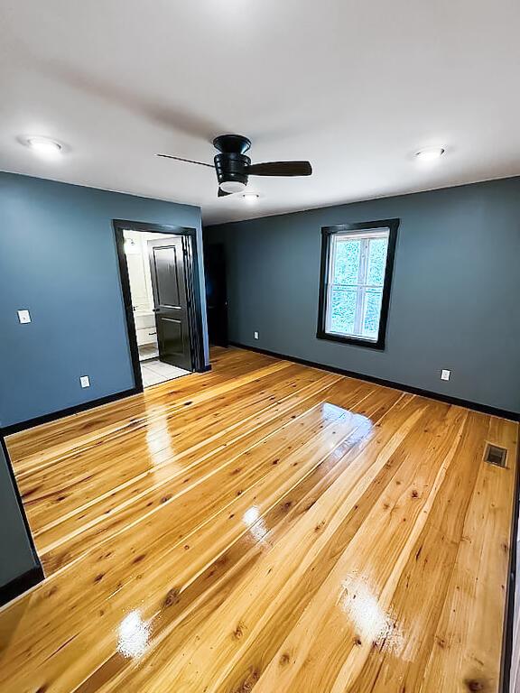 495 Pumpkin Creek Cir, Jamestown, KY 42629 - unfurnished room with light wood-style flooring, a ceiling fan, and baseboards