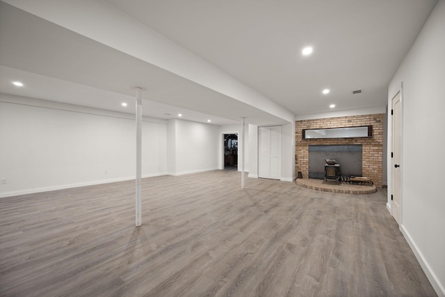 104 Barkley Ests, Nicholasville, KY 40356 - unfurnished living room with recessed lighting, wood finished floors, baseboards, and a wood stove