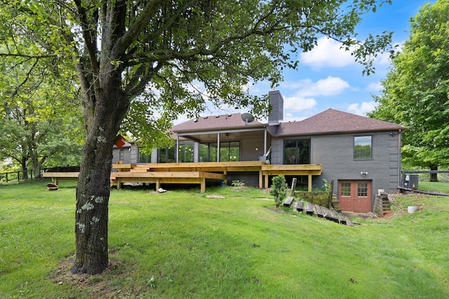 104 Barkley Ests, Nicholasville, KY 40356 - rear view of house featuring a chimney, a wooden deck, a sunroom, and brick siding