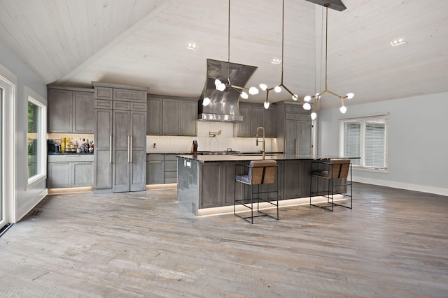 104 Barkley Ests, Nicholasville, KY 40356 - kitchen featuring vaulted ceiling, light wood-type flooring, wood ceiling, wall chimney exhaust hood, and a kitchen bar