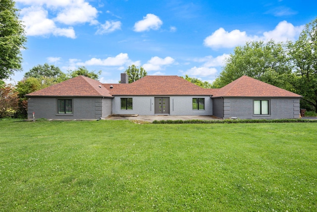 104 Barkley Ests, Nicholasville, KY 40356 - back of property with a patio area, a chimney, and a lawn