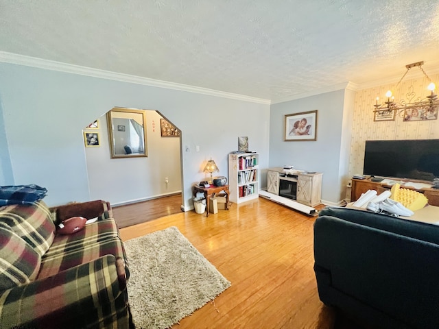 1465 Ky-1629, Corbin, KY 40701 - living area with wood finished floors, a chandelier, a textured ceiling, ornamental molding, and baseboards