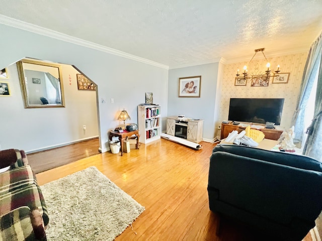 1465 Ky-1629, Corbin, KY 40701 - living room featuring a chandelier, light wood-style flooring, ornamental molding, baseboards, and a textured ceiling