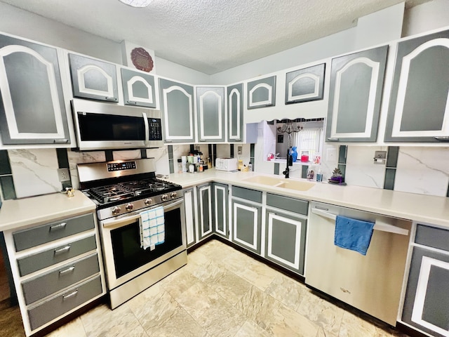 1465 Ky-1629, Corbin, KY 40701 - kitchen with appliances with stainless steel finishes, a sink, tasteful backsplash, a textured ceiling, and light countertops