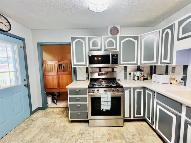 1465 Ky-1629, Corbin, KY 40701 - kitchen featuring stainless steel appliances, a textured ceiling, light countertops, and a sink