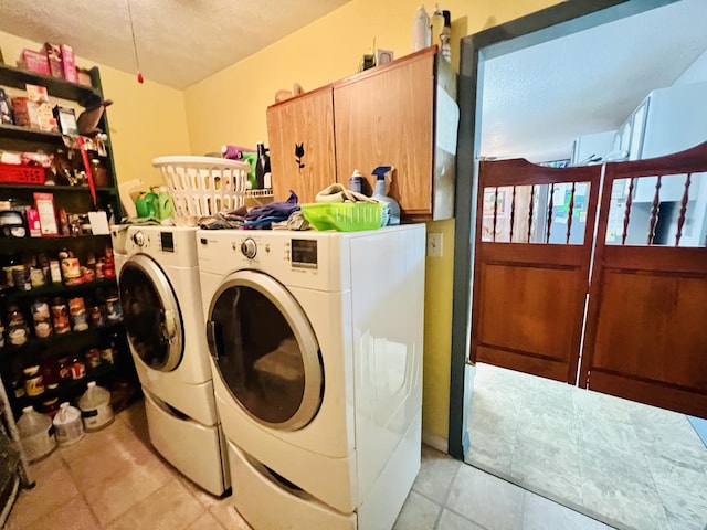 1465 Ky-1629, Corbin, KY 40701 - laundry room featuring cabinet space, a textured ceiling, washing machine and clothes dryer, and light tile patterned flooring