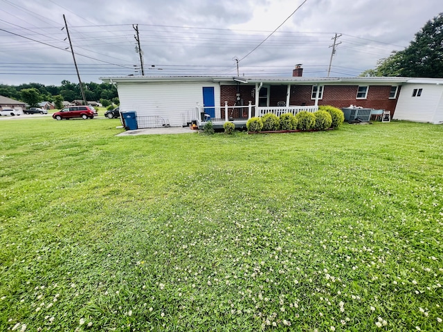 1465 Ky-1629, Corbin, KY 40701 - rear view of house featuring a lawn, brick siding, and a patio