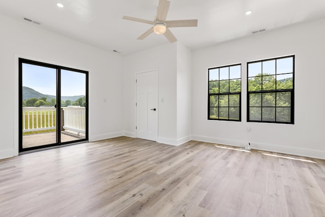 138 Hickory Grove Ln, Stanton, KY 40380 - unfurnished room featuring plenty of natural light, light wood-style flooring, ceiling fan, recessed lighting, and a mountain view