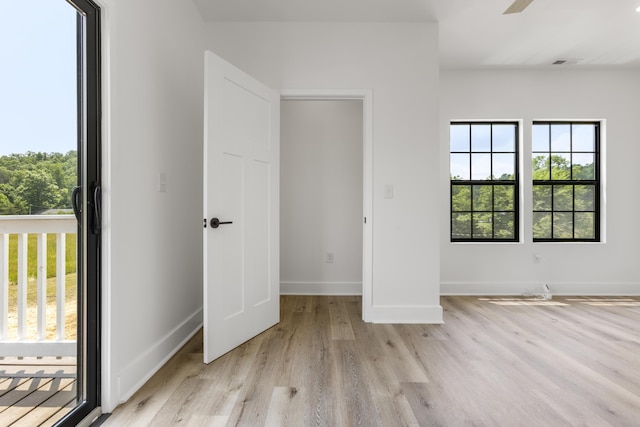 138 Hickory Grove Ln, Stanton, KY 40380 - unfurnished bedroom with multiple windows, light wood-style floors, and a ceiling fan