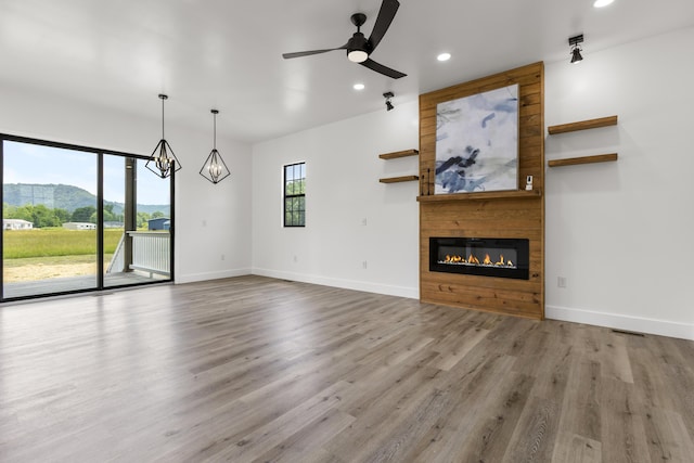138 Hickory Grove Ln, Stanton, KY 40380 - unfurnished living room with a fireplace, recessed lighting, wood finished floors, a chandelier, and a ceiling fan