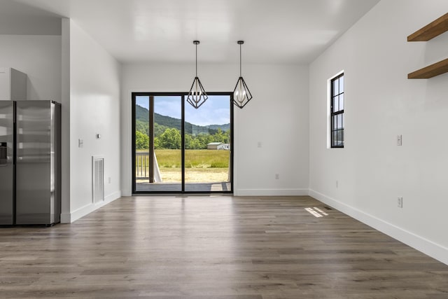 138 Hickory Grove Ln, Stanton, KY 40380 - unfurnished dining area with plenty of natural light, a chandelier, dark wood-style floors, and a mountain view