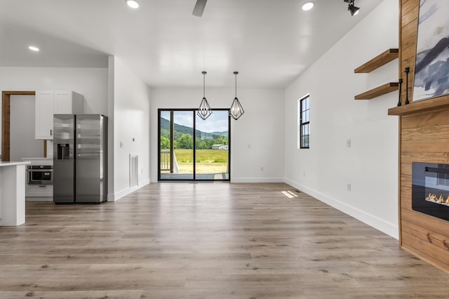 138 Hickory Grove Ln, Stanton, KY 40380 - unfurnished living room featuring plenty of natural light, a fireplace, recessed lighting, light wood-style flooring, and a chandelier