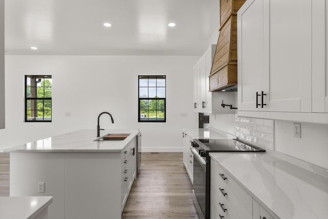 138 Hickory Grove Ln, Stanton, KY 40380 - kitchen with range with electric stovetop, light wood finished floors, custom range hood, recessed lighting, and white cabinetry