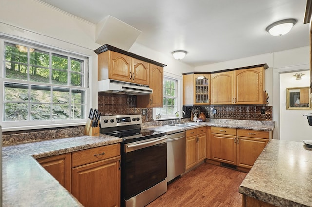 832 N 25th St, Middlesboro, KY 40965 - kitchen featuring appliances with stainless steel finishes, under cabinet range hood, a sink, dark wood finished floors, and tasteful backsplash