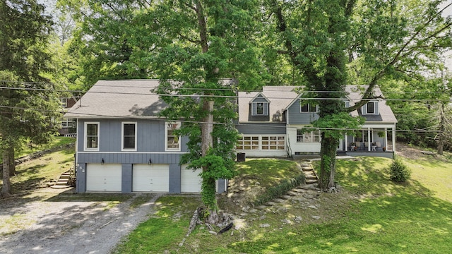 832 N 25th St, Middlesboro, KY 40965 - cape cod-style house with an attached garage, driveway, covered porch, a front lawn, and roof with shingles