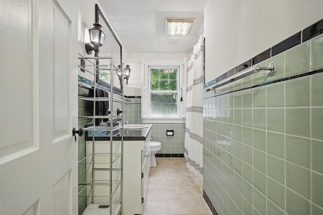 832 N 25th St, Middlesboro, KY 40965 - full bath with tile walls, vanity, toilet, tile patterned floors, and a shower with shower curtain