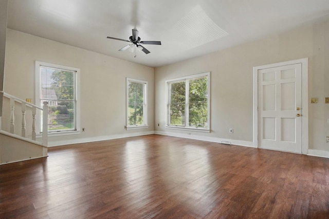 832 N 25th St, Middlesboro, KY 40965 - unfurnished living room with ceiling fan, healthy amount of natural light, wood finished floors, and baseboards