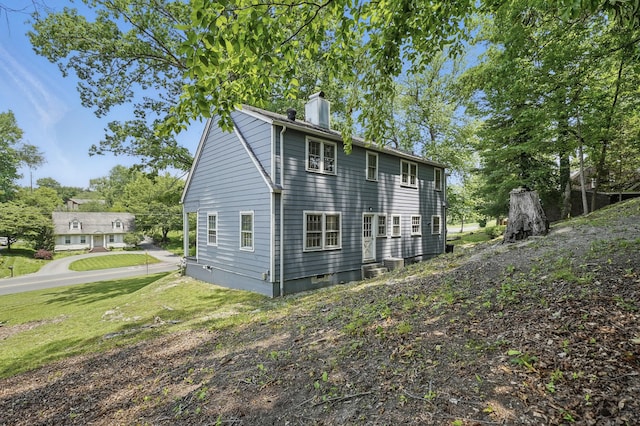832 N 25th St, Middlesboro, KY 40965 - view of property exterior featuring a chimney and a yard