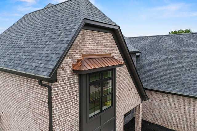 3852 Silver Charm Ln, Lexington, KY 40509 - exterior view of roof with shingles, brick siding, and a downspout