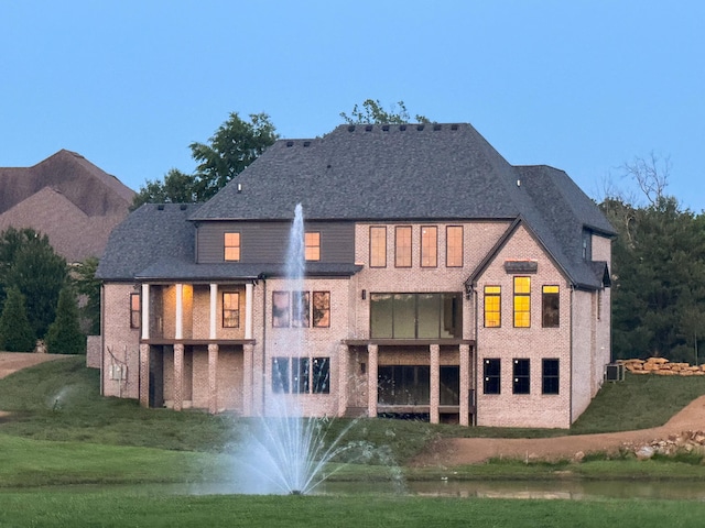 3852 Silver Charm Ln, Lexington, KY 40509 - rear view of house featuring a lawn, brick siding, cooling unit, and a balcony