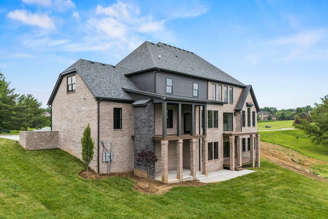 3852 Silver Charm Ln, Lexington, KY 40509 - back of property featuring a yard, brick siding, a patio area, and roof with shingles