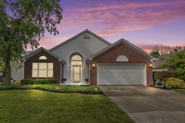 1217 Wyndham Hills Dr, Lexington, KY 40514 - view of front facade with driveway, a garage, brick siding, and a yard