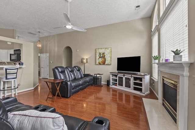 1217 Wyndham Hills Dr, Lexington, KY 40514 - living room featuring ceiling fan, wood finished floors, a high end fireplace, a textured ceiling, and baseboards