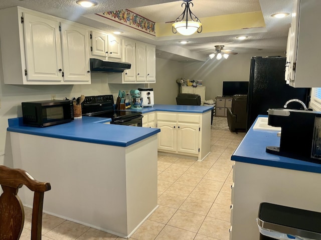 2953 Somerset Rd, London, KY 40741 - kitchen with black appliances, a peninsula, a textured ceiling, under cabinet range hood, and light tile patterned floors