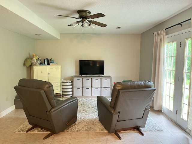 2953 Somerset Rd, London, KY 40741 - living area with a ceiling fan, a textured ceiling, light tile patterned flooring, and baseboards