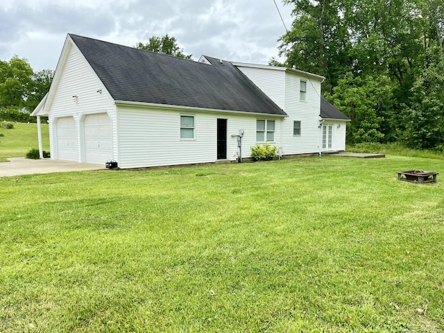 2953 Somerset Rd, London, KY 40741 - view of front of house featuring a shingled roof, a front lawn, an outdoor fire pit, and driveway
