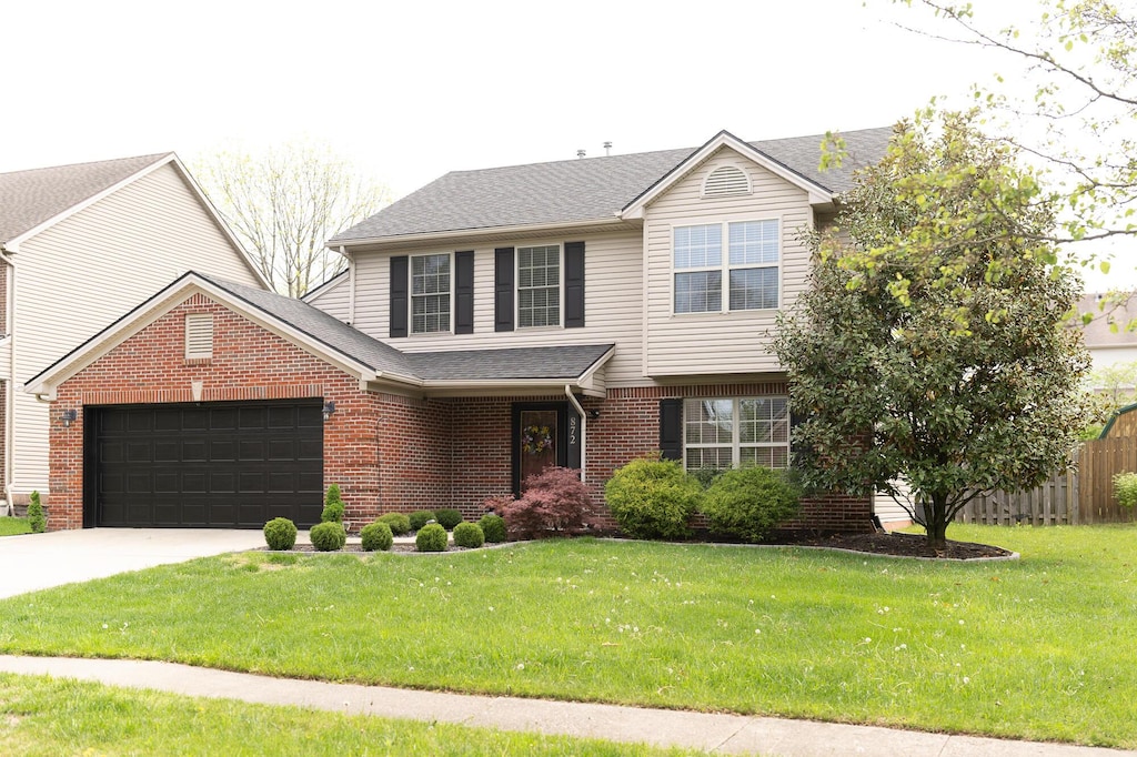 872 Calypso Breeze Dr, Lexington, KY 40515 - view of front of house featuring an attached garage, brick siding, driveway, and a shingled roof