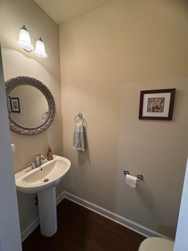 2765 Meadowsweet Ln, Lexington, KY 40511 - half bathroom featuring wood finished floors, toilet, and baseboards