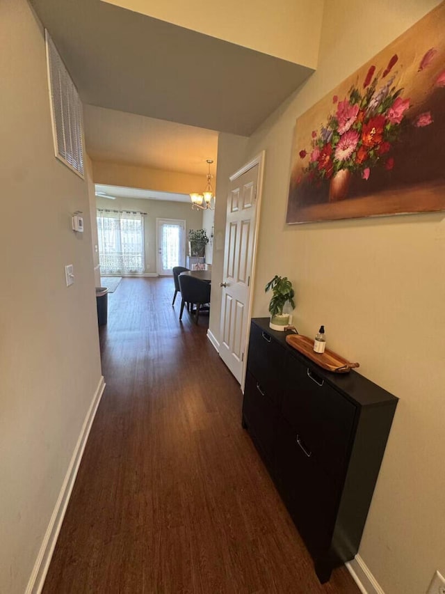 2765 Meadowsweet Ln, Lexington, KY 40511 - hallway featuring dark wood-style flooring, baseboards, and a chandelier