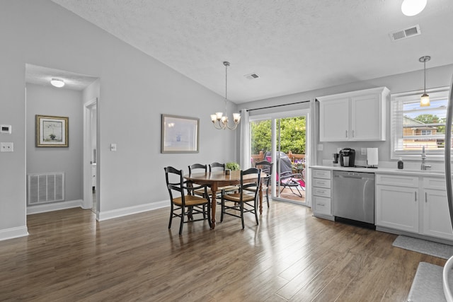 3648 Cottage Cir, Lexington, KY 40513 - dining area with a textured ceiling, vaulted ceiling, dark wood-style floors, plenty of natural light, and a chandelier