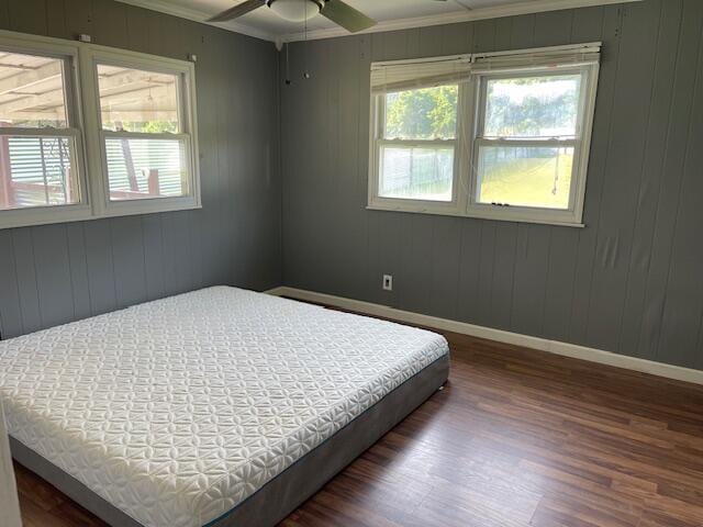 600 S 38th St, Middlesboro, KY 40965 - bedroom with wood finished floors, crown molding, baseboards, a ceiling fan, and wooden walls