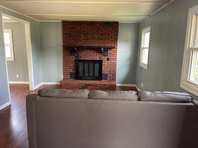 600 S 38th St, Middlesboro, KY 40965 - living area featuring wood finished floors, baseboards, a brick fireplace, and crown molding