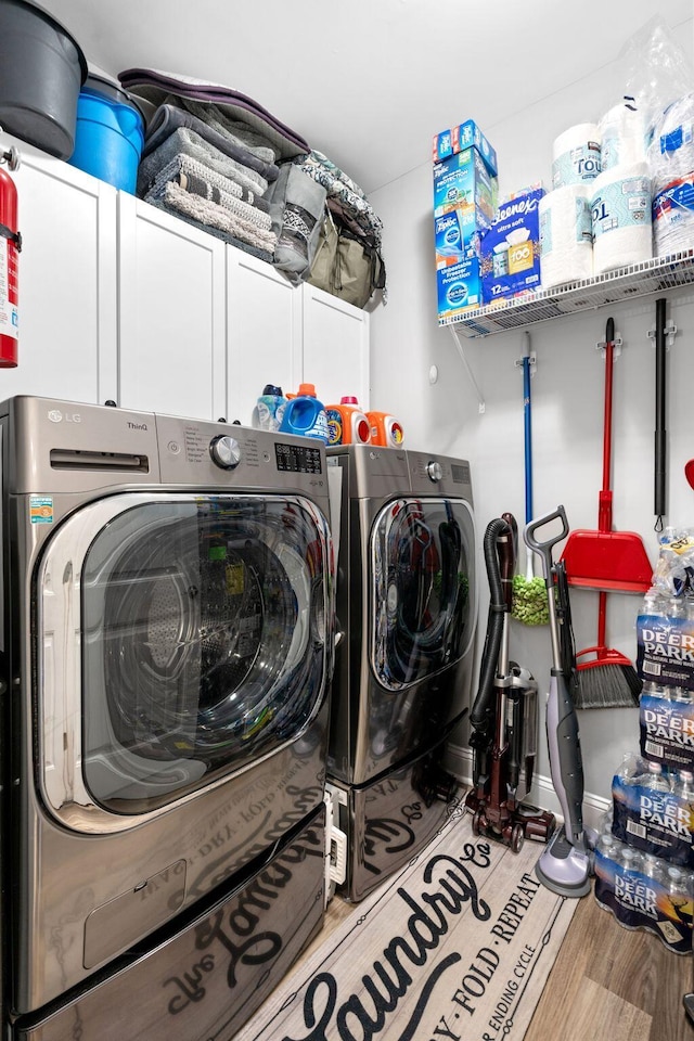 116 Hackberry Ct, Frankfort, KY 40601 - laundry area featuring cabinet space, washer and clothes dryer, and wood finished floors